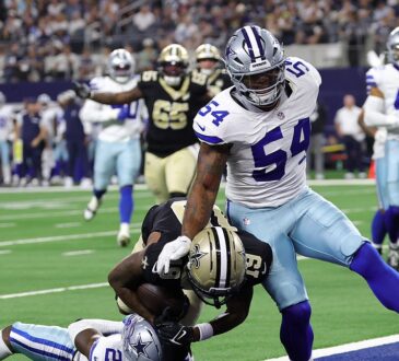 New Orleans Saints wide receiver Barion Brown pulls in a touchdown catch as Cowboys cornerback Caelen Carson falls beneath him.