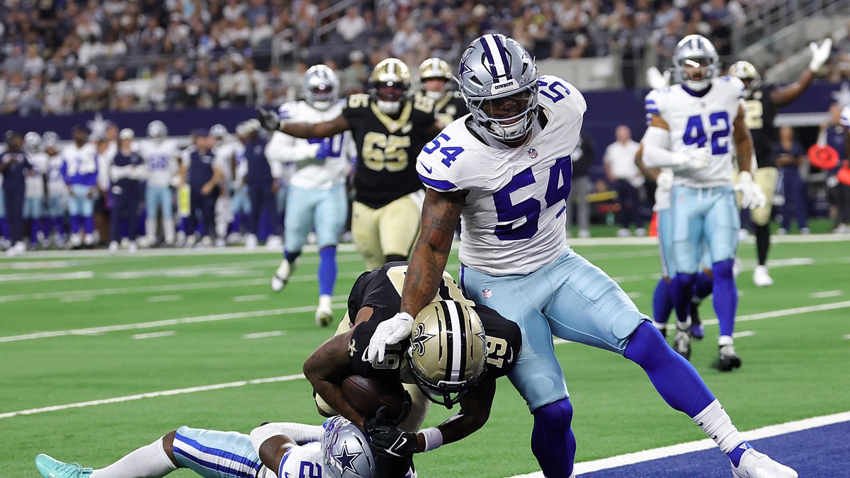 New Orleans Saints wide receiver Barion Brown pulls in a touchdown catch as Cowboys cornerback Caelen Carson falls beneath him.