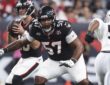 Houston Texans tackle Blake Fisher sets in pass protection with his quarterback dropping back behind him.