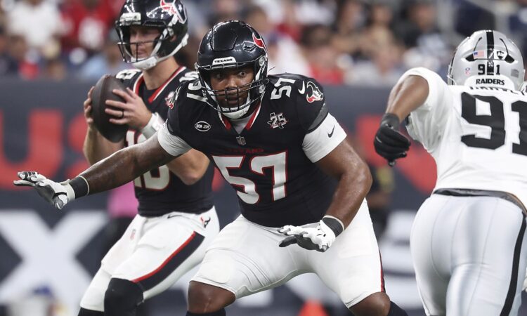 Houston Texans tackle Blake Fisher sets in pass protection with his quarterback dropping back behind him.