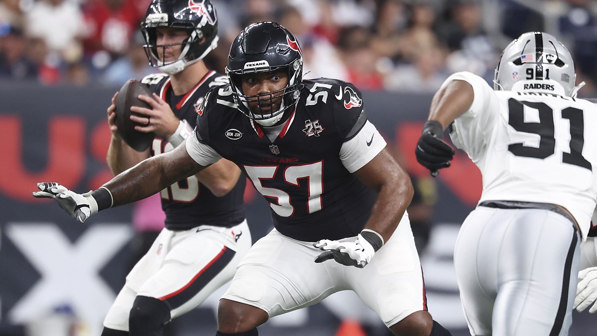 Houston Texans tackle Blake Fisher sets in pass protection with his quarterback dropping back behind him.