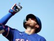 Texas Rangers right fielder Brandon Nimmo points skyward after reaching base at Sutter Health Park.
