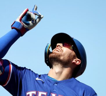 Texas Rangers right fielder Brandon Nimmo points skyward after reaching base at Sutter Health Park.