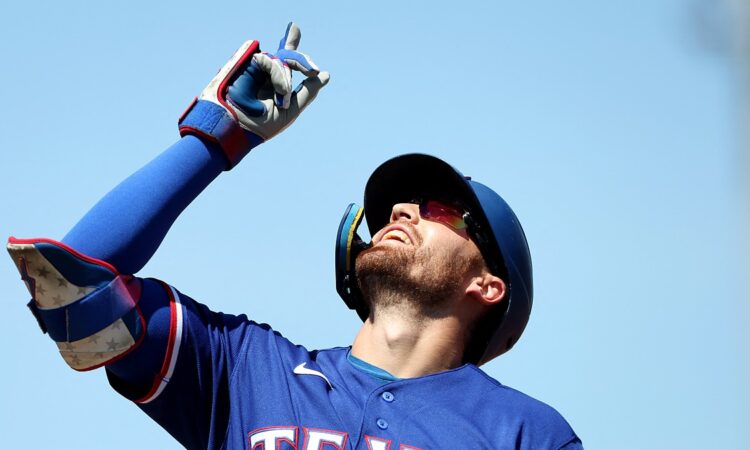 Texas Rangers right fielder Brandon Nimmo points skyward after reaching base at Sutter Health Park.