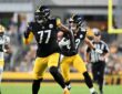 Pittsburgh Steelers offensive tackle Broderick Jones runs downfield looking for a block as tight end Robert Tonyan carries.