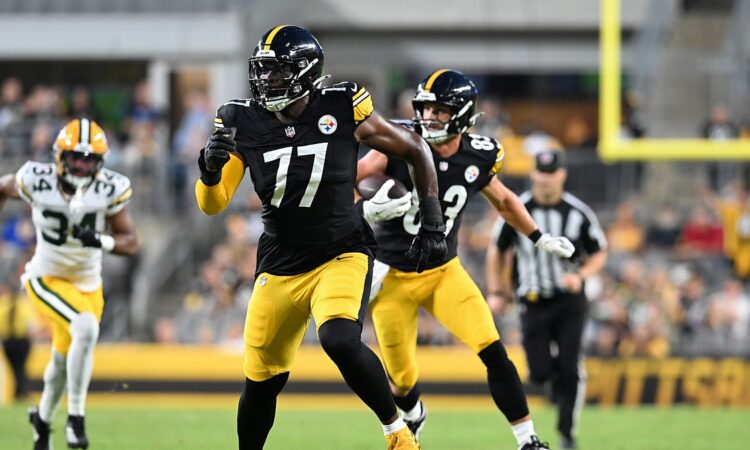 Pittsburgh Steelers offensive tackle Broderick Jones runs downfield looking for a block as tight end Robert Tonyan carries.