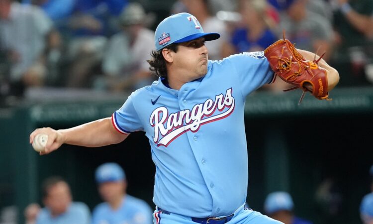 Texas Rangers pitcher Cal Quantrill winds up to deliver in a powder blue jersey at Globe Life Field.