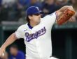 Texas Rangers pitcher Cal Quantrill winds up to deliver a pitch in his white home uniform.