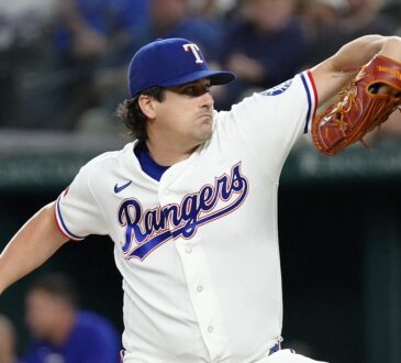 Texas Rangers pitcher Cal Quantrill winds up to deliver a pitch in his white home uniform.