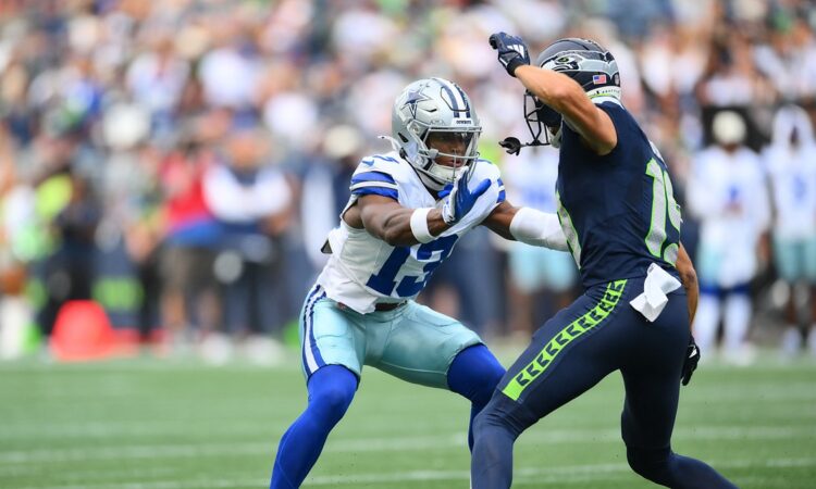 Dallas Cowboys safety Caleb Downs jams Seattle Seahawks wide receiver Jake Bobo at the line of scrimmage.
