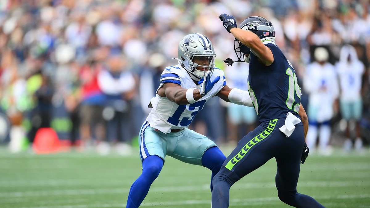 Dallas Cowboys safety Caleb Downs works to jam Seattle Seahawks wide receiver Jake Bobo at the line.