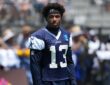 Dallas Cowboys safety Caleb Downs looks off to the side in a practice jersey during training camp.