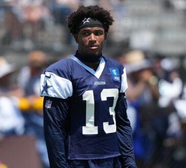 Dallas Cowboys safety Caleb Downs looks off to the side in a practice jersey during training camp.