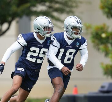 Dallas Cowboys rookie defensive backs Devin Moore and Caleb Downs break into a run during a minicamp drill.