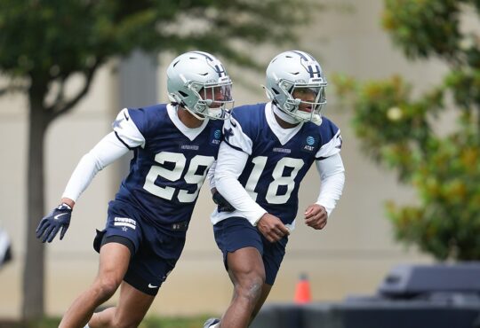 Dallas Cowboys rookie defensive backs Devin Moore and Caleb Downs break into a run during a minicamp drill.