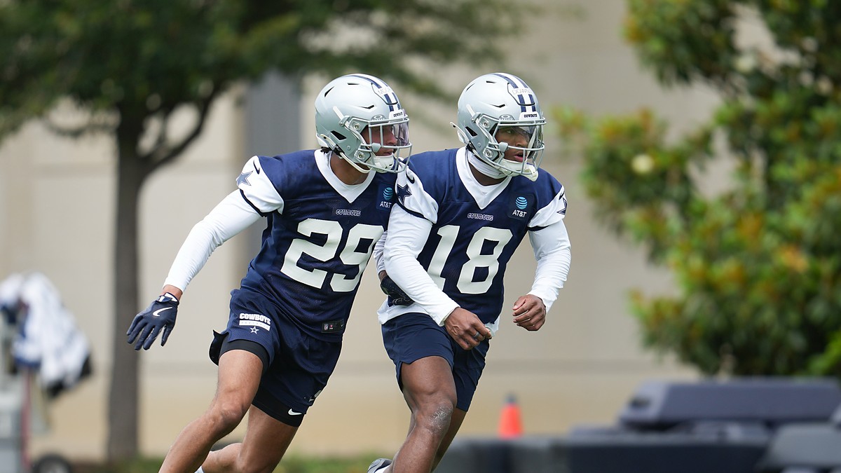 Dallas Cowboys rookie defensive backs Devin Moore and Caleb Downs break into a run during a minicamp drill.
