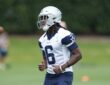 Dallas Cowboys wide receiver Camden Brown jogs across the practice field in a white No. 6 practice jersey and helmet.