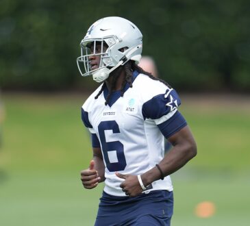 Dallas Cowboys wide receiver Camden Brown jogs across the practice field in a white No. 6 practice jersey and helmet.
