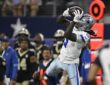 Dallas Cowboys wide receiver Camden Brown leaps and hauls in a pass along the sideline at AT&T Stadium.