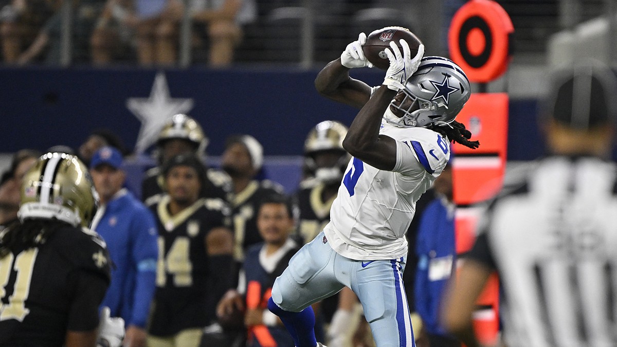 Dallas Cowboys wide receiver Camden Brown leaps and hauls in a pass along the sideline at AT&T Stadium.