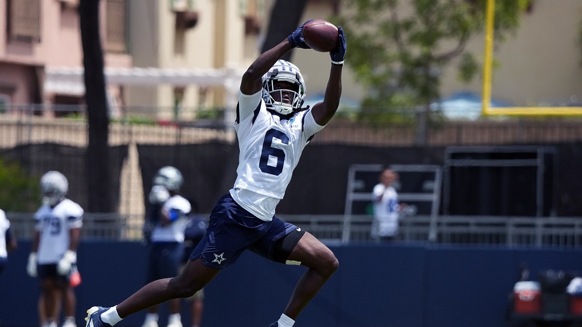 Dallas Cowboys wide receiver Camden Brown extends overhead to haul in a pass during training camp practice.