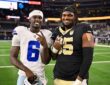 Dallas Cowboys wide receiver Camden Brown and New Orleans Saints guard Jeremiah Wright pose on the field postgame.