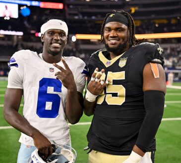 Dallas Cowboys wide receiver Camden Brown and New Orleans Saints guard Jeremiah Wright pose on the field postgame.