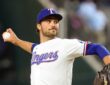 Texas Rangers pitcher Carter Baumler releases a pitch in his white home uniform at Globe Life Field.