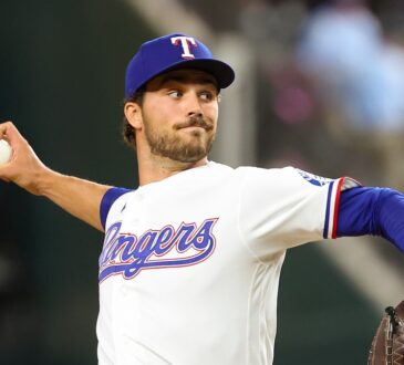 Texas Rangers pitcher Carter Baumler releases a pitch in his white home uniform at Globe Life Field.
