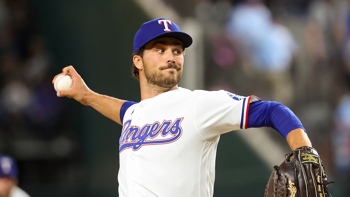 Texas Rangers pitcher Carter Baumler releases a pitch in his white home uniform at Globe Life Field.