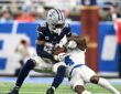 Dallas Cowboys wide receiver CeeDee Lamb secures a catch as Detroit Lions cornerback D.J. Reed wraps him up.