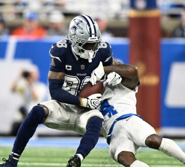 Dallas Cowboys wide receiver CeeDee Lamb secures a catch as Detroit Lions cornerback D.J. Reed wraps him up.