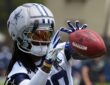 Cowboys receiver CeeDee Lamb reaches out to catch a ball while wearing a Guardian helmet cap at training camp
