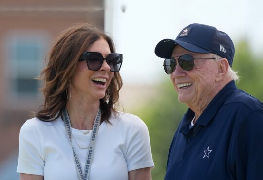 Dallas Cowboys chief brand officer Charlotte Jones laughs alongside owner Jerry Jones at training camp.