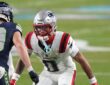 New England Patriots cornerback Christian Gonzalez shadows Seattle Seahawks wide receiver Cooper Kupp at the line.