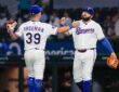 Texas Rangers third baseman Cody Freeman and first baseman Jake Burger slap hands on the field after a win.