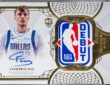 A one-of-one Topps Cooper Flagg Rookie Debut Patch Autograph card in a protective case, showing his signature and an NBA debut jersey patch.