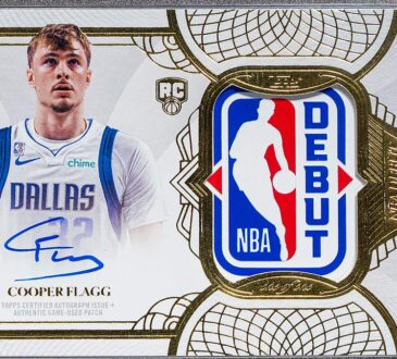 A one-of-one Topps Cooper Flagg Rookie Debut Patch Autograph card in a protective case, showing his signature and an NBA debut jersey patch.