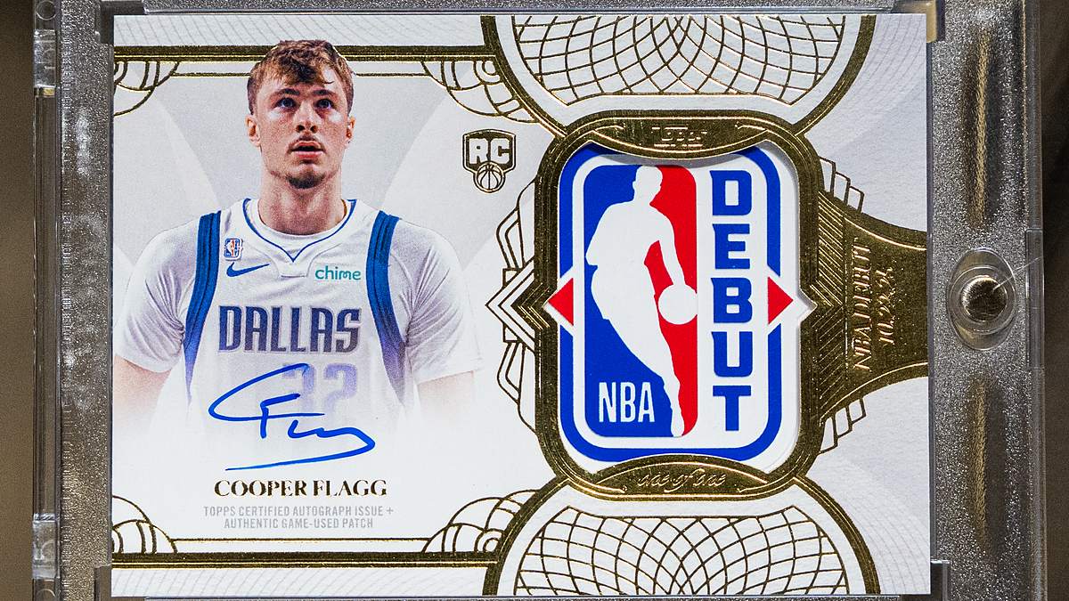 A one-of-one Topps Cooper Flagg Rookie Debut Patch Autograph card in a protective case, showing his signature and an NBA debut jersey patch.