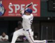 Texas Rangers shortstop Corey Seager makes contact with a pitch, the ball just off the bat in front of him.