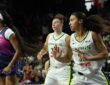 Washington Mystics guard Cotie McMahon reacts as Dallas Wings players Jessica Shepard and Azzi Fudd run upcourt behind her.