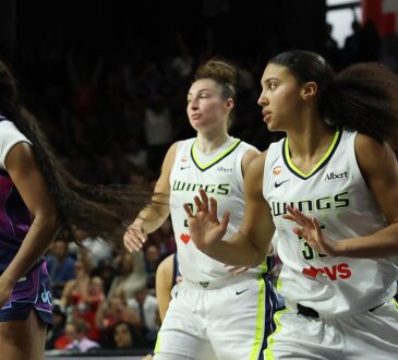 Washington Mystics guard Cotie McMahon reacts as Dallas Wings players Jessica Shepard and Azzi Fudd run upcourt behind her.