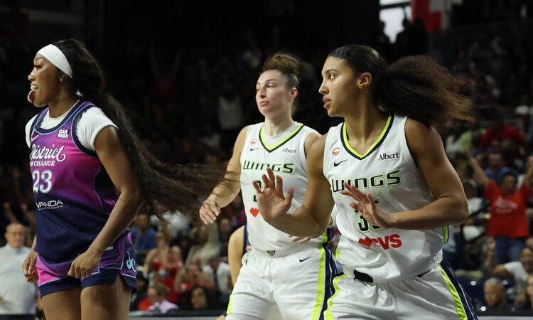 Washington Mystics guard Cotie McMahon reacts as Dallas Wings players Jessica Shepard and Azzi Fudd run upcourt behind her.