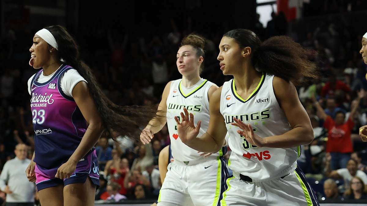 Washington Mystics guard Cotie McMahon reacts as Dallas Wings players Jessica Shepard and Azzi Fudd run upcourt behind her.