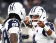 Dallas Cowboys quarterback Dak Prescott gestures while talking with wide receiver CeeDee Lamb during pregame warmups.