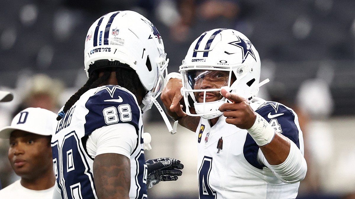Dallas Cowboys quarterback Dak Prescott gestures while talking with wide receiver CeeDee Lamb during pregame warmups.