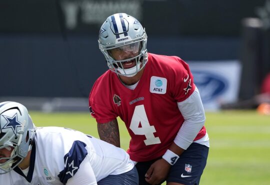 Dallas Cowboys quarterback Dak Prescott lines up under center as Cooper Beebe prepares to snap the ball.