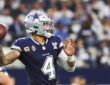 Dallas Cowboys quarterback Dak Prescott cocks the ball to throw in a navy No. 4 jersey.