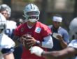 Dallas Cowboys quarterback Dak Prescott drops back with the football during a training camp drill.