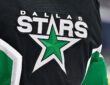 The Dallas Stars crest, a green star ringed in white, stitched on goaltender Jake Oettinger's black jersey.